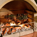 Buschbeck Rotisserie inside the oven while roasting chicken