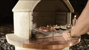 a person putting food to grill on a Buschbeck St Moritz 3-in-1 Outdoor Fireplace 