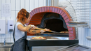 Ligurian - Commercial Pizza Oven being used to put pizza on the inside