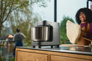 Ooni Halo Pro - Spiral Mixer Charcoal Grey on top of the table with people on background