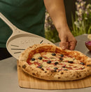 Person using Ooni 9" Pizza Turning Peel  getting pizza