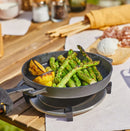 Person cooking using Ooni Cast Iron Skillet