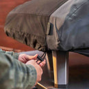 person tightening Ooni Koda 2 Max Cover