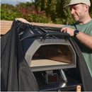 person using Ooni Table and Oven Cover 